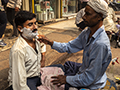 Man Getting a Shave on Old Delhi Street