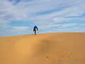 Photographer trekking the dunes, Gobi