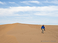 Photographer trekking the dunes, Gobi