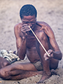 Bushman (San) Tribesman Prepares Arrow Shaft